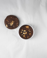 Top view of triple chocolate chip cookie, flat lay of dark chocolate cookie, chocolate cookie on parchment paper, bakery style chocolate cookies