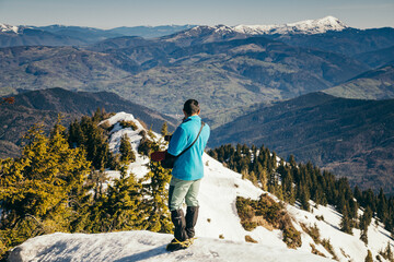 Mountains, coniferous forest in the snow, spring, winter, tourist