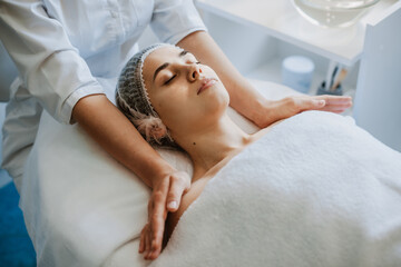 Fototapeta na wymiar Top view of a woman receiving shoulders massage at spa salon. Beauty skin. Skin care. Spa body care.