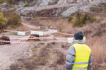 Back view of a race official staring at the circuit during a rally. Concept of racing cars,...