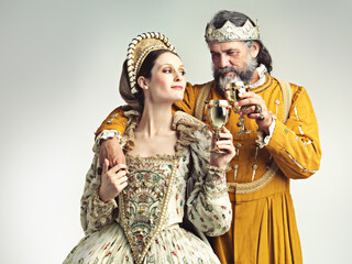 It's good to be royal. Studio shot of a king and queen drinking out of goblets.