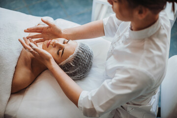 Obraz na płótnie Canvas Face massage with oil on the table at spa salon. . Beauty skin female face. Body care. Beauty treatment.