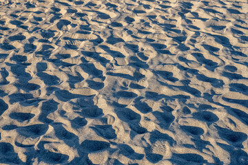 Fototapeta na wymiar Shadows of Sandy Footprints