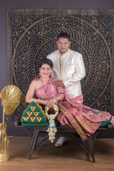 Couple's pre-wedding Couple in traditional Thai dress happy man kissing couple	
