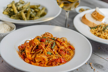 Full table of italian meals on plates and wine