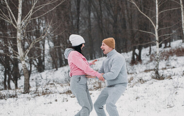 Fototapeta na wymiar couple walking in winter park. Couple love. Winter time. 