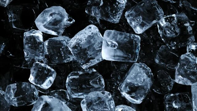 Super slow motion of falling ice cubes separated on black background. Filmed on high speed cinema camera, 1000 fps. Speed ramp effect.