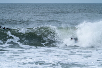 Bodyboarder performing a tube trick
