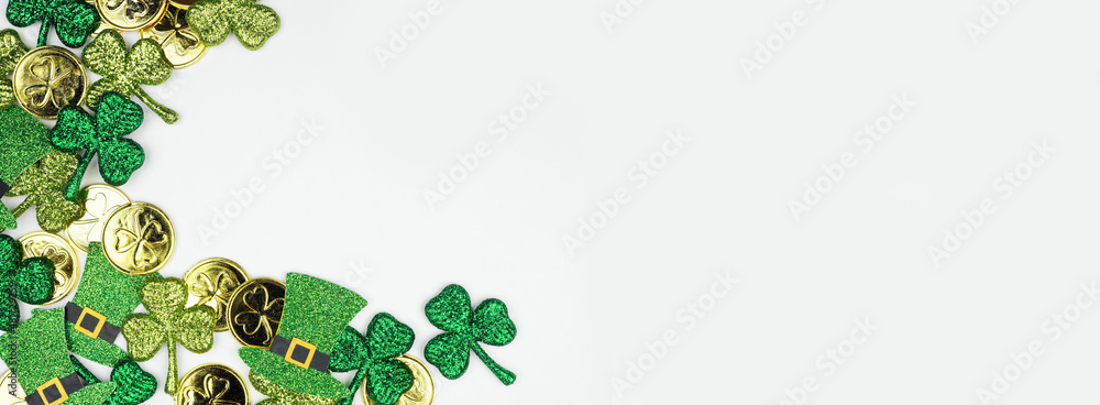 Poster st patricks day corner border against a white banner background. overhead view with gold coins, sham