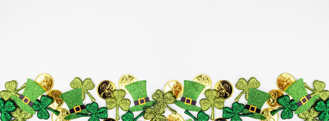 St Patricks Day bottom border against a white banner background. Top down view with gold coins,...