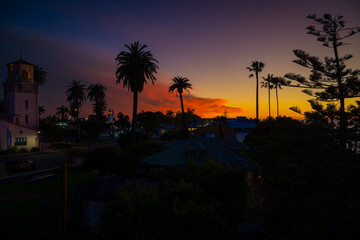 2022-01-19 BRIGHT ORANGE SUNSET IN LA JOLLA CALIFORNIA  FROM PROSPECT STREET WITH CHRUCH, BISHOP SCHOOL AND NEW ART MUSEUM IN THE BACKGROUND