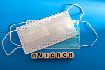 Double mask - protection against OMICRON. protective medical masks on a blue background.