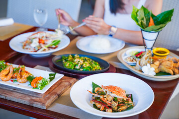 woman is eating food at restaurant