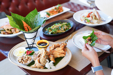 woman is eating food at restaurant