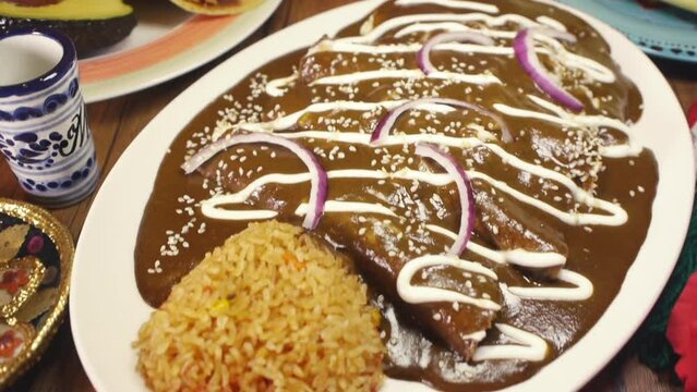 Mouth watering Mole Enchiladas on table
