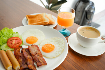 American breakfast set on wooden table.