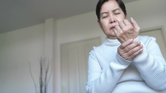 Senior asian woman massaging hand suffering from beriberi,Disease causing inflammation of the nerves