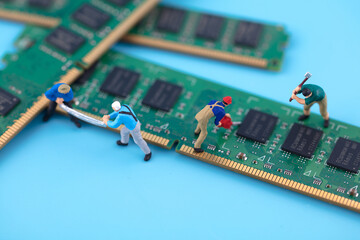 Miniature creative workers engaged in chip development