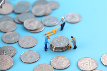 Miniature scene workers transporting dollar coins