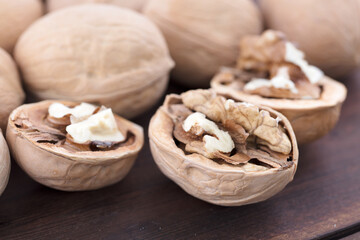 The nuts are exposed from the broken dried walnuts