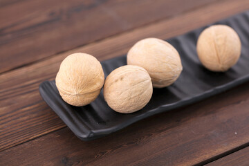 Dried walnuts are on a long plate