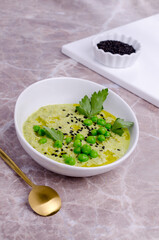 Green cream soup with peas and sesame seeds