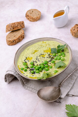 Green cream soup with peas and sesame seeds