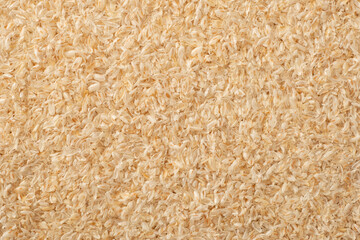 Full frame food background of whole psyllium husk, top view.