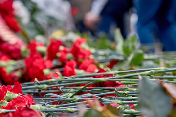 Many flowers lie on the granite of the monument to Lenin .