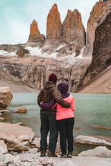 Hiking Couple Look at The three towers of Torres del Paine National Park