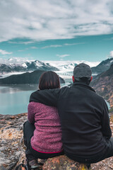 Fototapeta premium Hiking couple resting and looking out at landscape