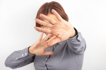 beautiful businesswoman expresses emotional protest and thoughts with her own hands on a white...