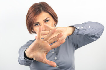 beautiful businesswoman expresses emotional protest and thoughts with her own hands on a white background