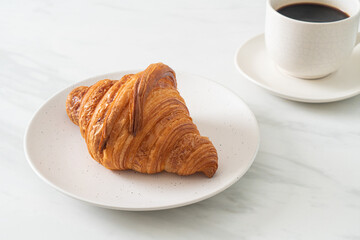 fresh croissant on white plate