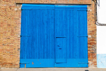 Obraz na płótnie Canvas Weathered blue warehouse door