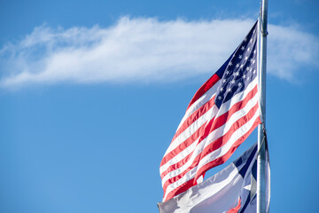 United States Flag Waving in Wind with Texas Flag Below