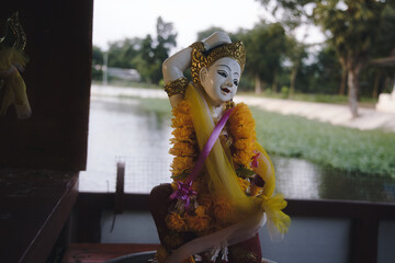 Beautiful female white gold buddha statue beautifully decorated in an open temple in Hua Hin in Thailand