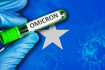 Somalia outbreak of omicron variant. Hand holds a test tube with covid-19 virus omicron in front of...