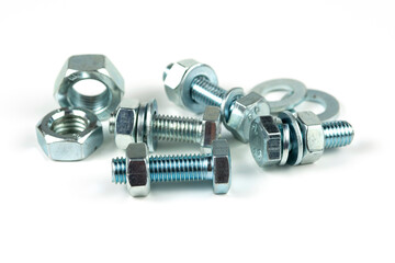 metal bolts and nuts with round washers close-up on a white background