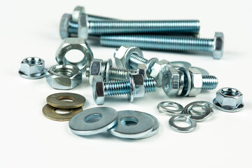 metal bolts and nuts with round washers close-up on a white background