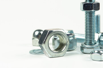 metal bolts and nuts with round washers close-up on a white background