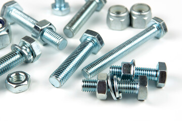 metal bolts and nuts with round washers close-up on a white background