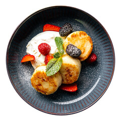 Isolated russian cottage cheese pancakes syrniki with berries and cream