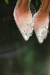 bridal shoes surrounded by fresh green leaves