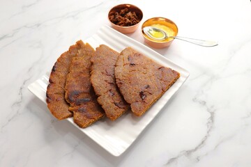 Sweet roti made out of rice flour, jaggery, and ghee. Gud ki roti. gur ki roti, jaggery Bhakri, meethi gud ki roti cooked in banana leaf. Winter food. Copy space.