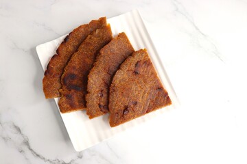 Sweet roti made out of rice flour, jaggery, and ghee. Gud ki roti. gur ki roti, jaggery Bhakri, meethi gud ki roti cooked in banana leaf. Winter food. Copy space.