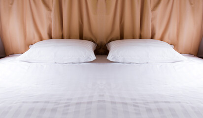 Two pillows on white bed