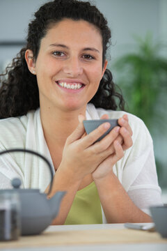 happy young woman drinking tea
