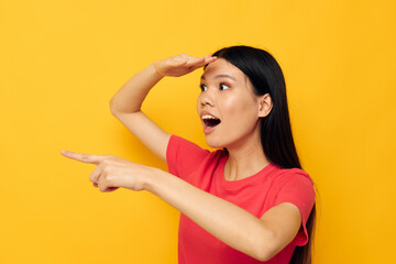 Portrait Asian beautiful young woman in a red t-shirt posing emotions fun yellow background unaltered