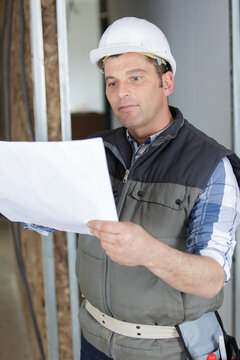 picture of construction site engineer looking at plan